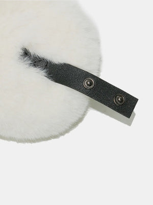Ivory shearling aviator trapper hat detail with black faux leather strap and snaps.