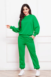 Green relaxed fit loungewear set with crewneck sweatshirt and drawstring pants.
