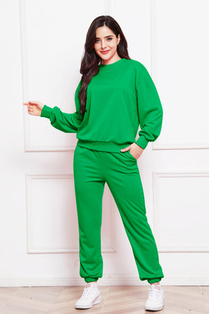 Green relaxed fit loungewear set with crewneck sweatshirt and drawstring pants.