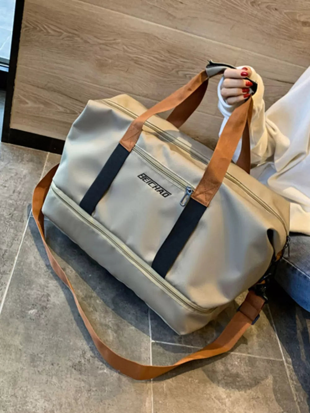 Premium Oxford cloth travel bag in beige with dual handles and a crossbody strap.