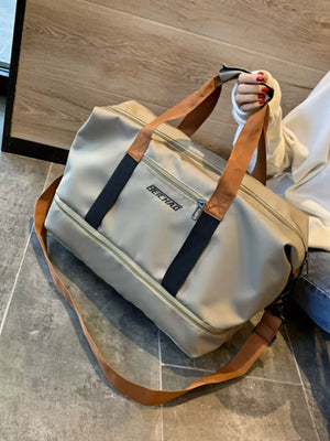 Premium Oxford cloth travel bag in beige with dual handles and a crossbody strap.