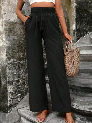 Black linen palazzo trousers with drawstring waist and side buttons.