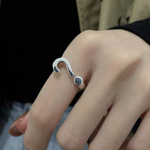 Sterling silver open ring with question mark detail on a finger