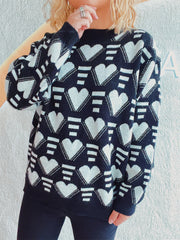 Black acrylic knit jumper with white geometric heart pattern, crew neck, long sleeves.