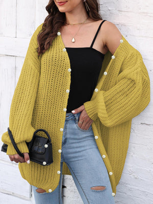 Yellow balloon sleeve cardigan with pearl buttons and open knit detail.
