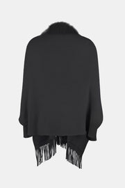 Black faux fur trimmed fringe cape with a relaxed fit.