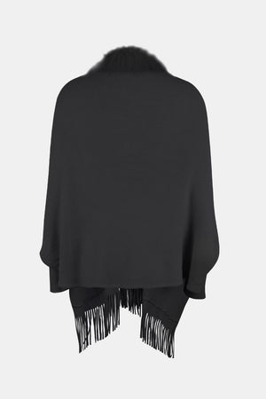 Black faux fur trimmed fringe cape with a relaxed fit.