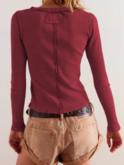 Ribbed button-up second-skin top in Rust with long sleeves and a seam detail down the back.