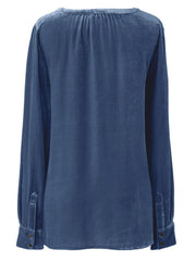 Dusty blue velvet blouse with gathered yoke and buttoned cuffs.
