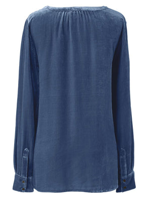 Dusty blue velvet blouse with gathered yoke and buttoned cuffs.