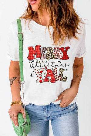 White graphic tee with Merry Christmas Yall text in patchwork patterns and Christmas lights.