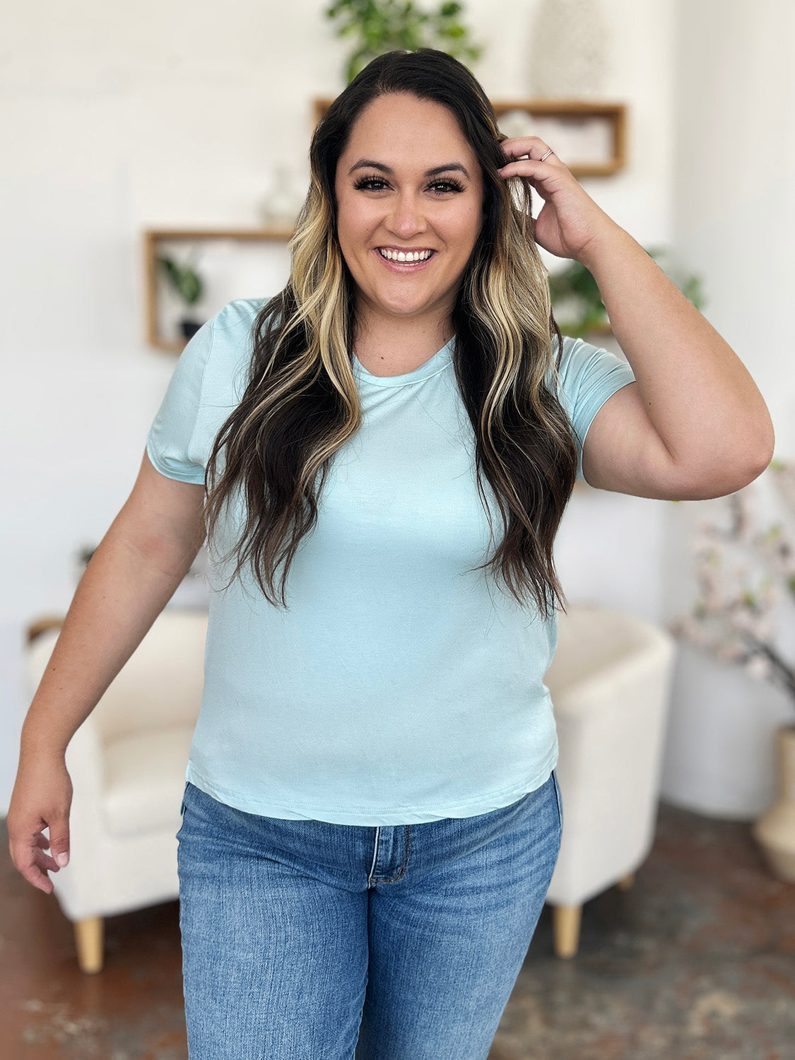 Slit hemline crew neck tee in Mint Blue, made from bamboo fabric, styled with jeans.