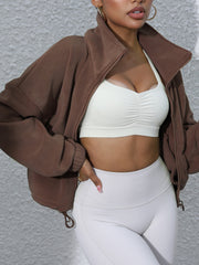 Coffee brown fleece cropped jacket with funnel neck and zipper closure.