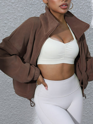 Coffee brown fleece cropped jacket with funnel neck and zipper closure.