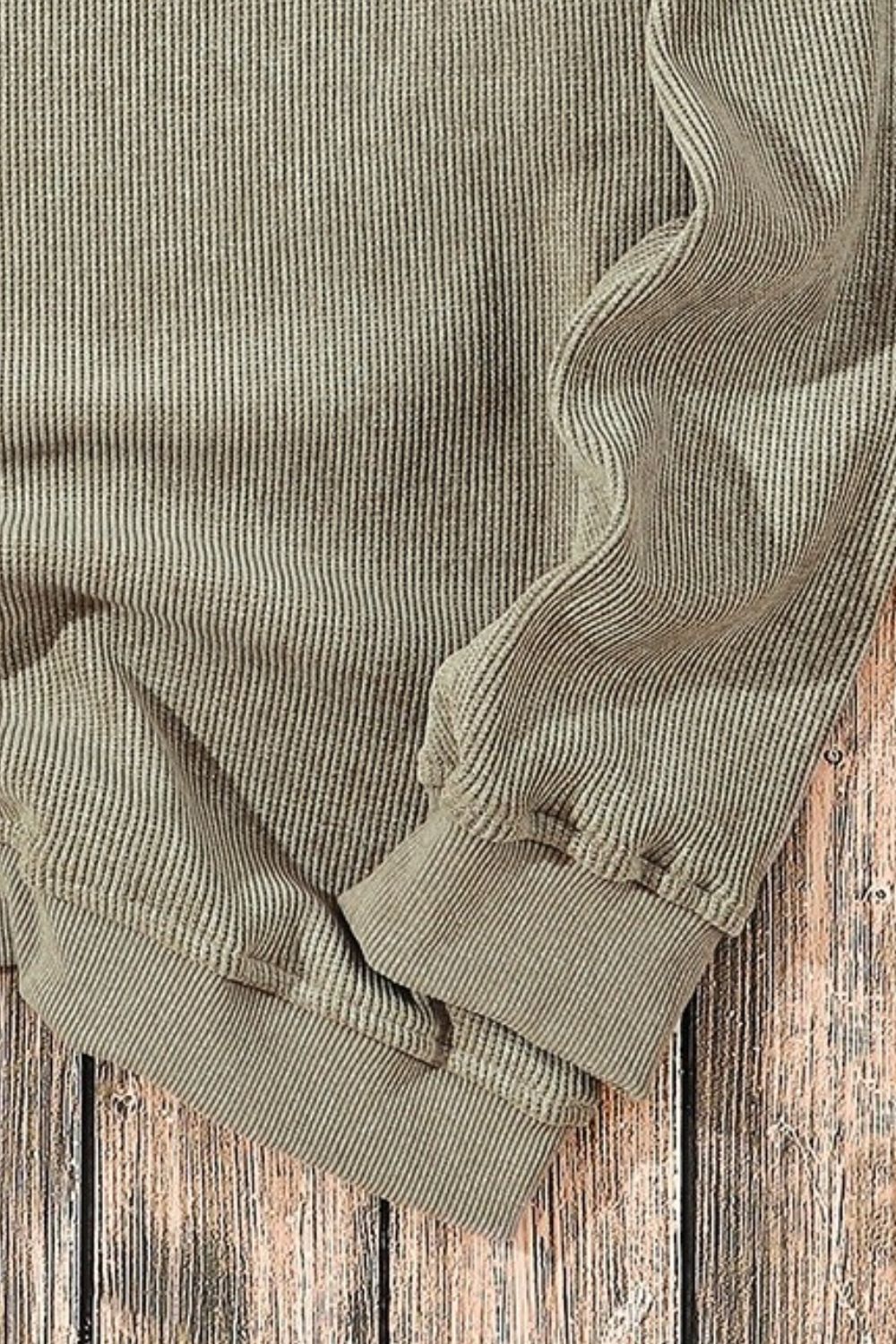 Sage ribbed knit sweater with subtle pinstripe detail and cuffed sleeves.