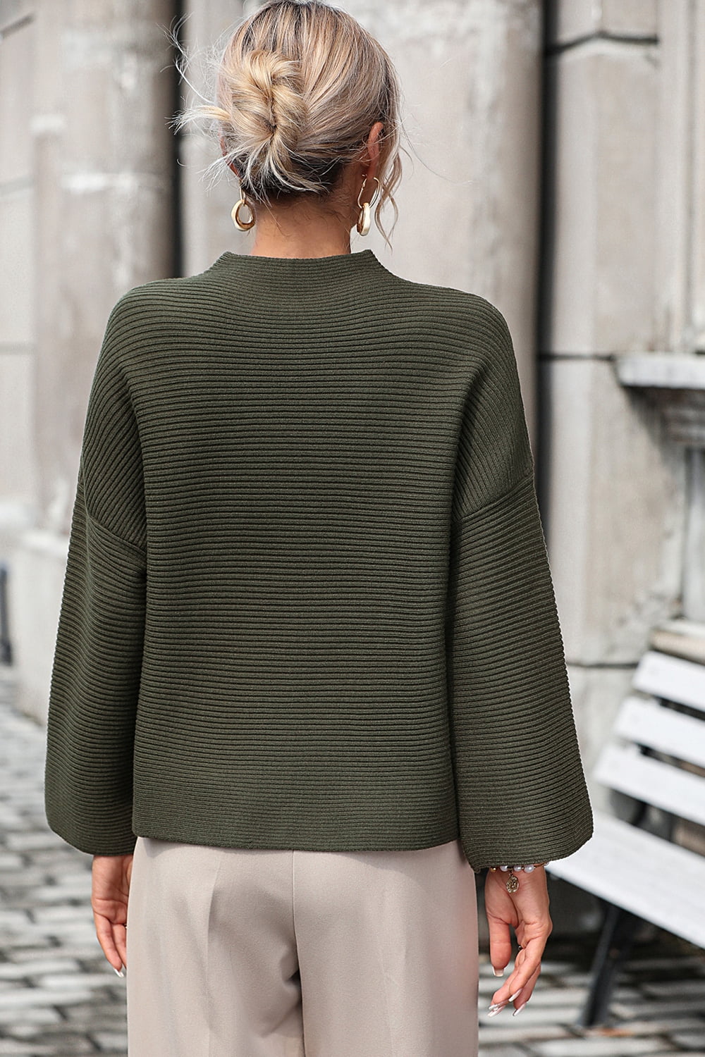 Army green ribbed mock neck sweater with volume sleeves.
