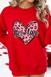 Red crewneck sweatshirt with a pink leopard print heart graphic and "Be Mine" text.