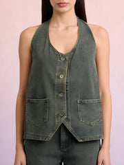 Button-down denim halter vest in gray with two front pockets and a V-neckline.