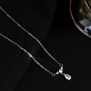 Elegant silver necklace with a teardrop zircon pendant and small accent stones.