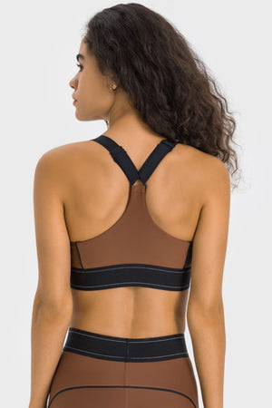 Performance sports bra in chocolate brown with black crossback straps and band.