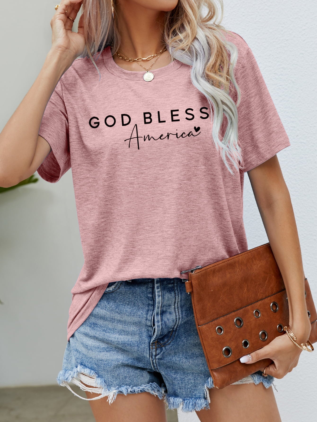Blush pink crew neck t-shirt with black "God Bless America" graphic print