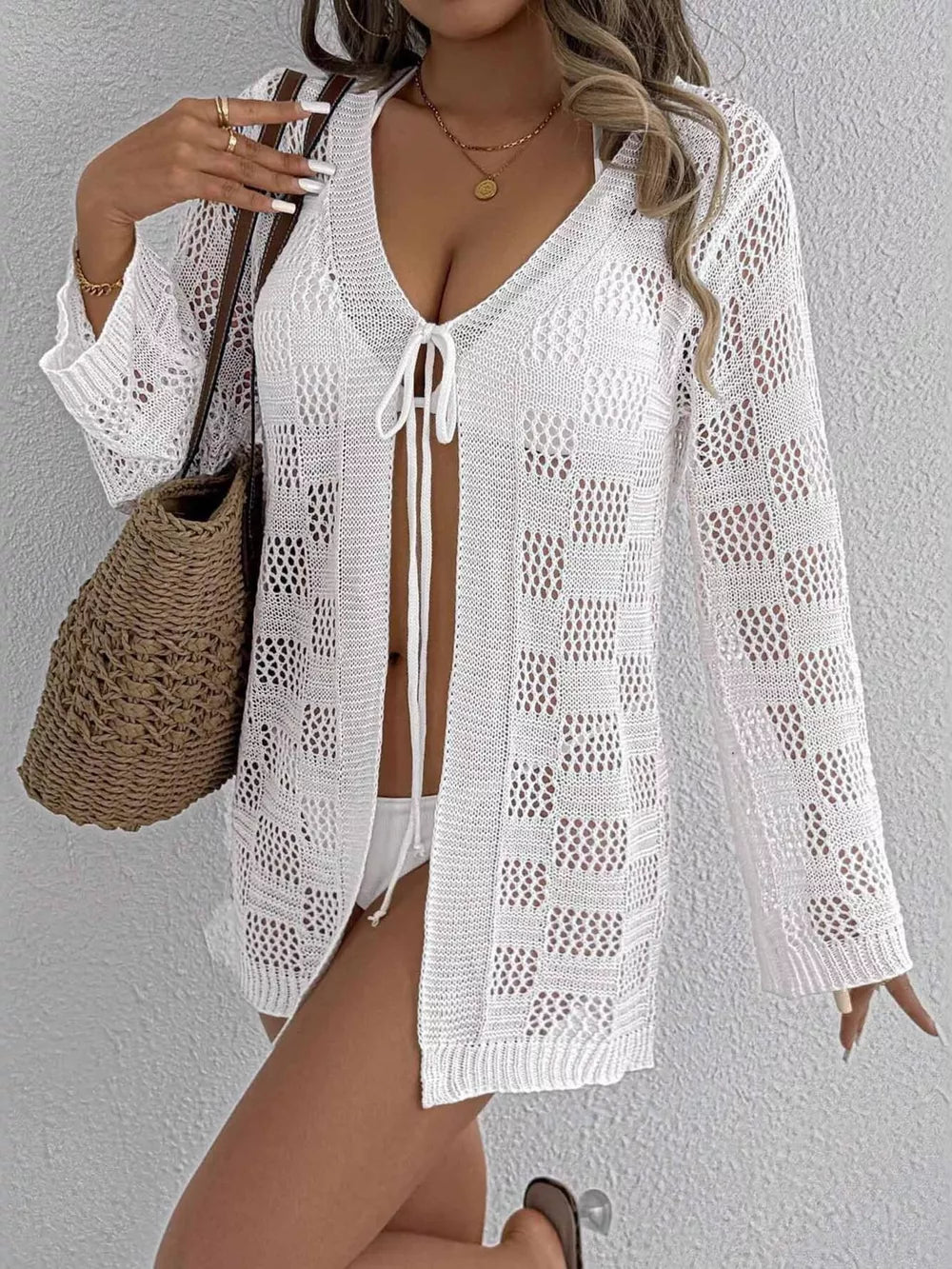 White openwork tie-front crochet cover-up with a v-neck and long sleeves.