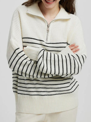 Ribbed stripe half-zip knit sweater in cream with black horizontal stripes and a silver zipper.