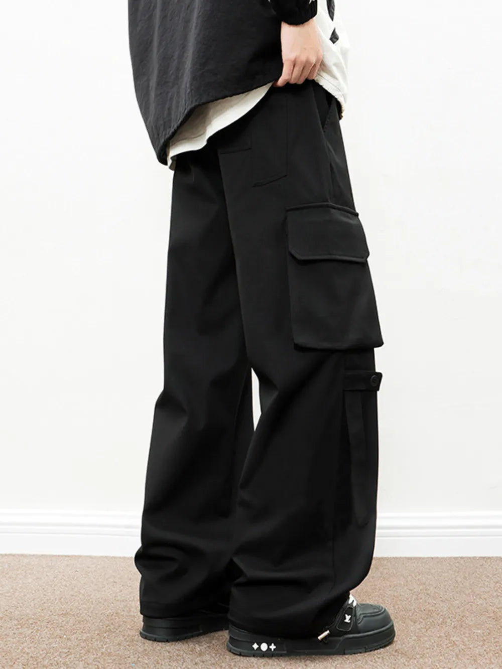 Black cargo pants with drawstring comfort and large side pockets.