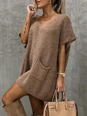 Relaxed knit tunic in taupe with V-neck, short sleeves, and front pockets.