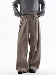 Men's wide leg check trousers in beige and brown with a tie belt and pleats.