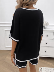 Black knit lounge set with white contrast trim on neckline, sleeves, and shorts.