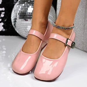 Pink patent buckle strap Mary Jane loafers with a rose detail buckle.