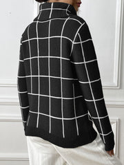 Black gridwork turtleneck sweater with white lines, knit fabric, long sleeves.