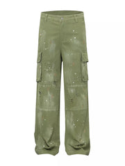 Green distressed cargo pants with paint splatters and ripped accents