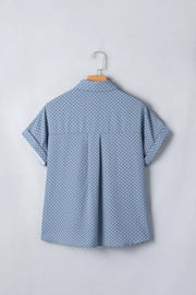 Blue polka dot cuffed short sleeve polyester shirt with button front and collar.