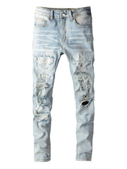 Light wash distressed slim-fit jeans with ripped detailing