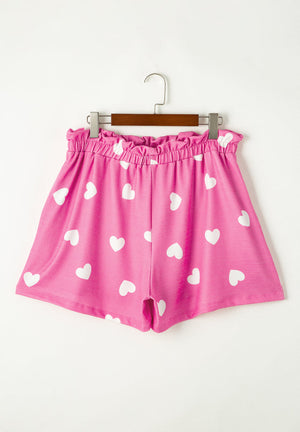 Hot pink pajama shorts with white hearts and elastic waist.