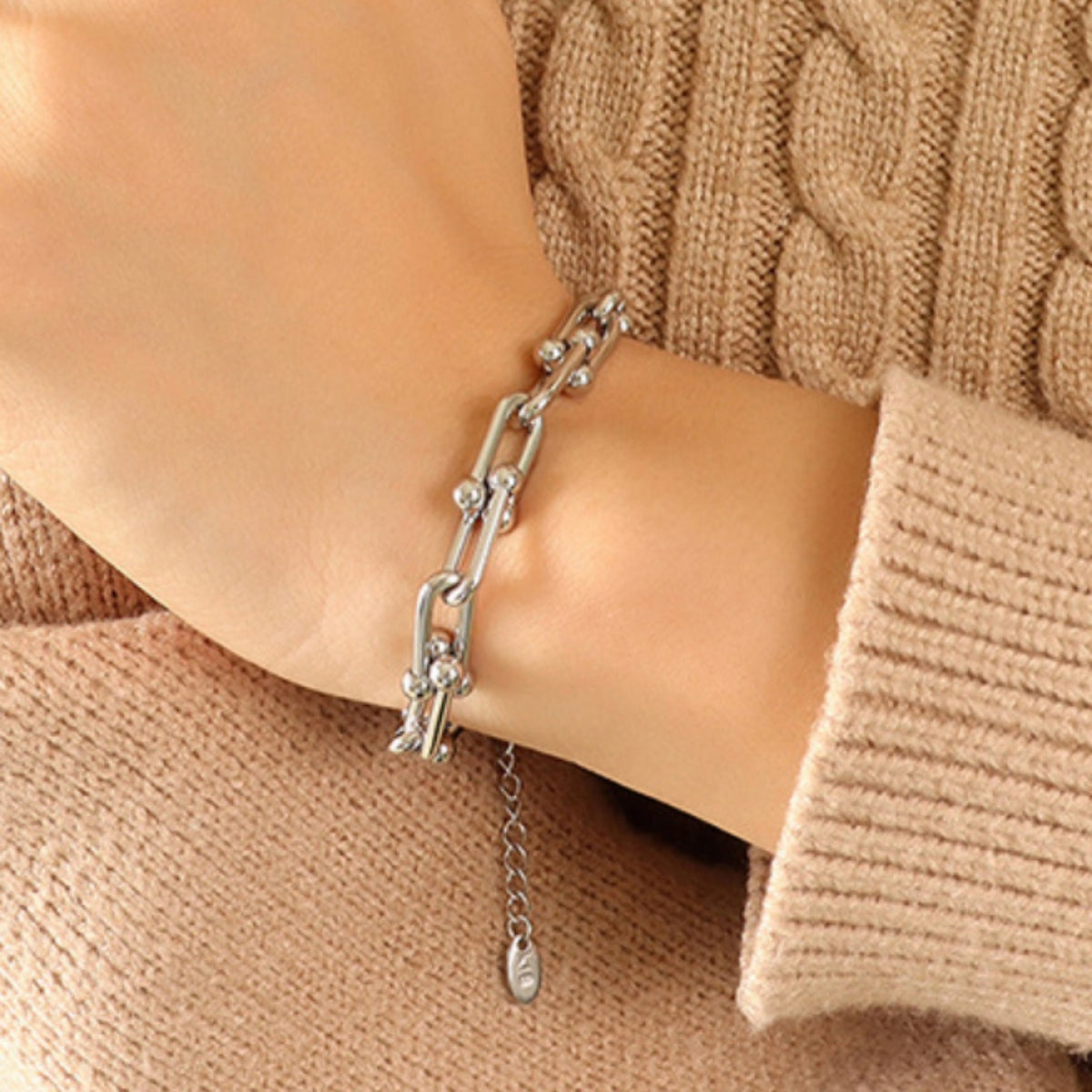 Silver sculptural link chain bracelet with beaded accents and adjustable extender.