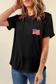 Black t-shirt with rolled sleeves and embroidered American flag detail on the chest.