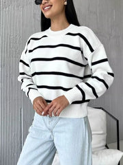 Classic striped knit sweater with round neck in white and black.