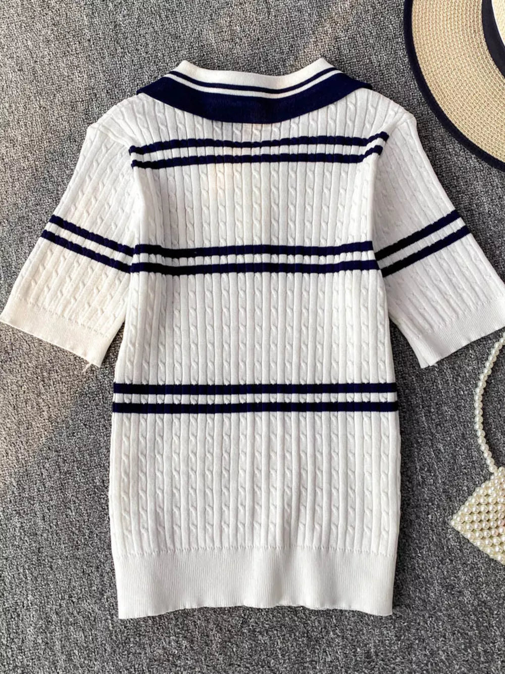 White cable knit polo t-shirt with navy stripes and collar.