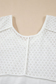 White lace-inset dolman sleeve blouse with a scoop neckline and open knit detail.
