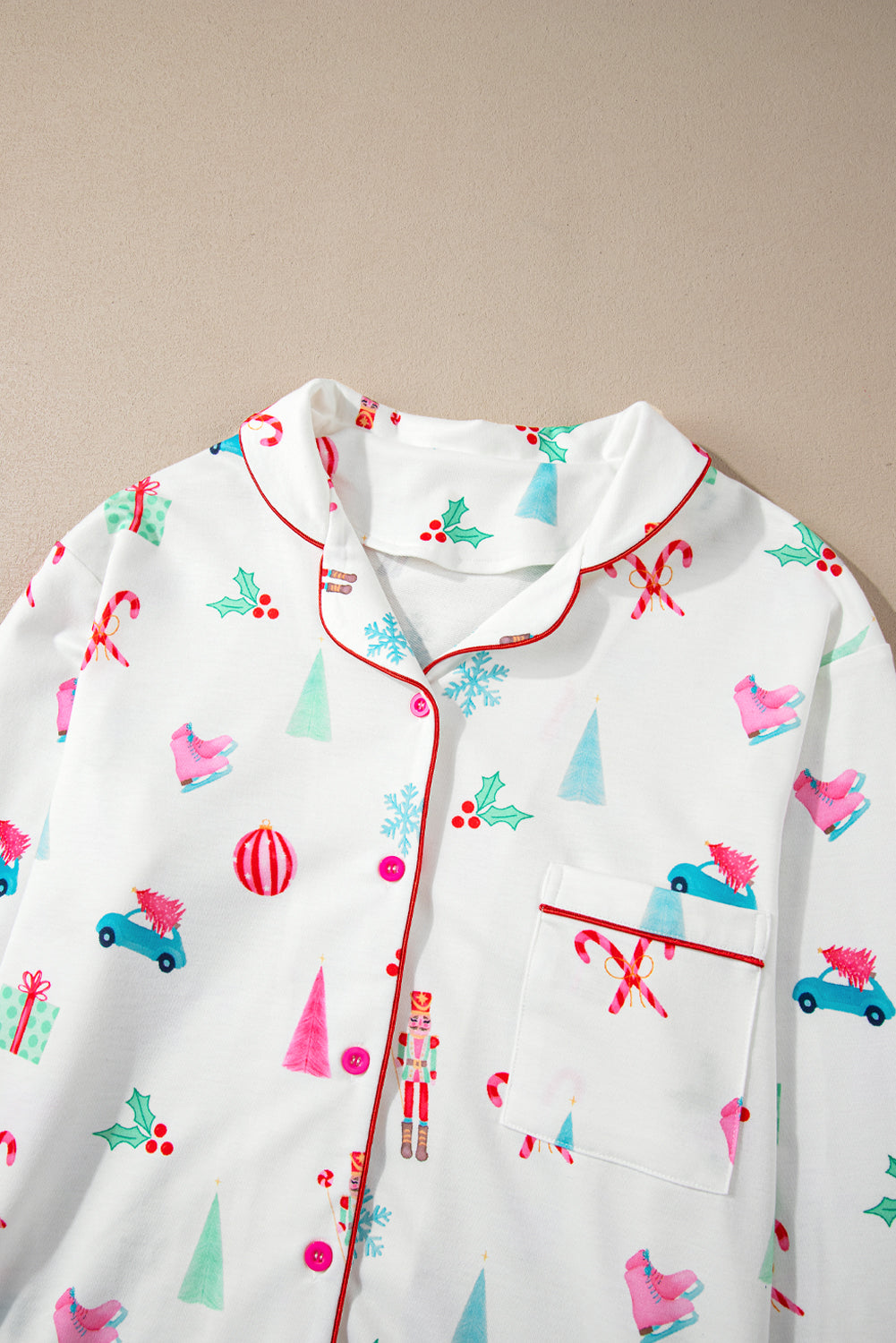 White pajama set with festive Christmas print and contrast trim.