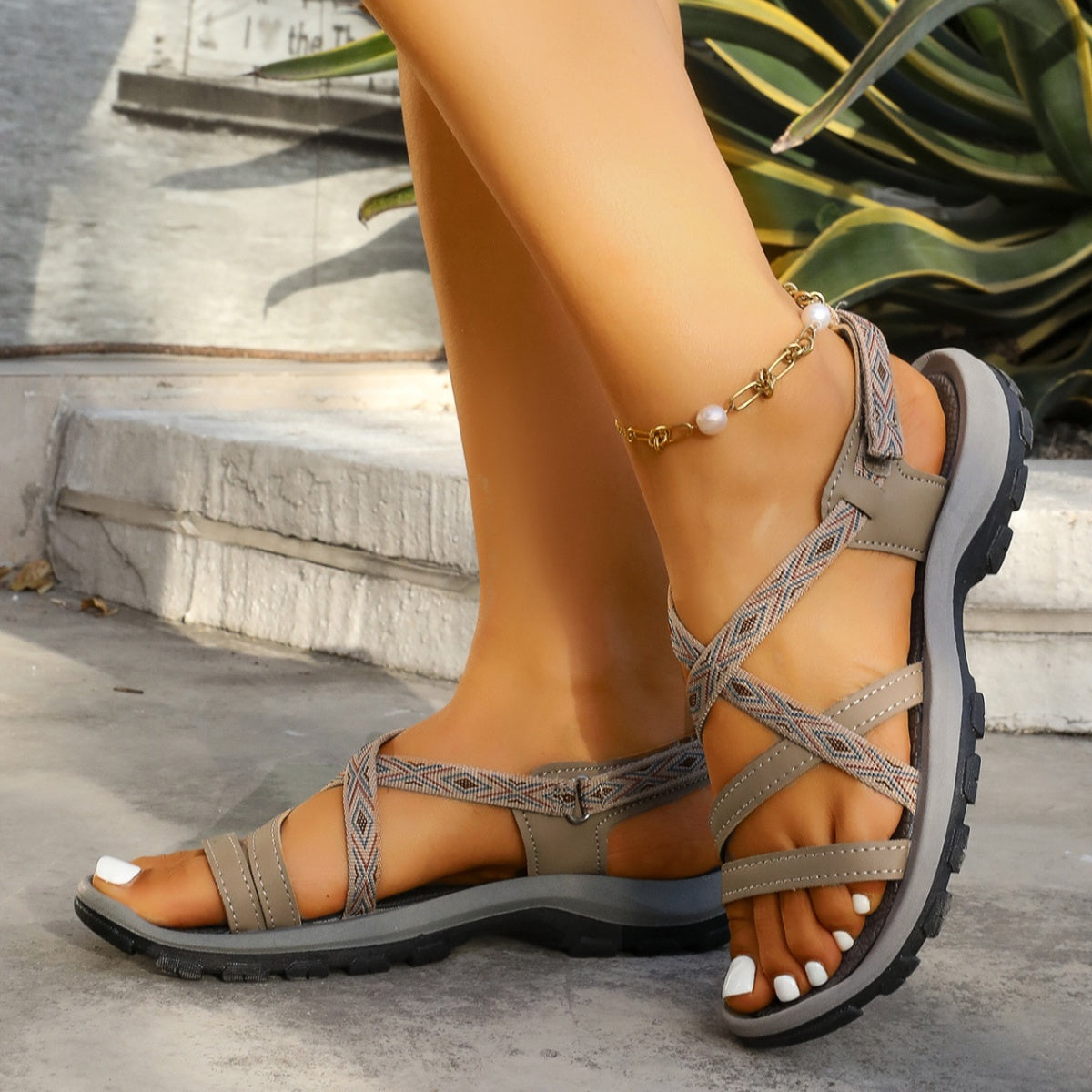 Khaki textured ankle strap open-toe sandals with crisscross straps and adjustable buckle.