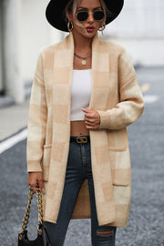 Tan oversized checkerboard knit duster coat with pockets and open front.