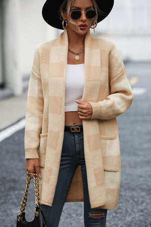 Tan oversized checkerboard knit duster coat with pockets and open front.