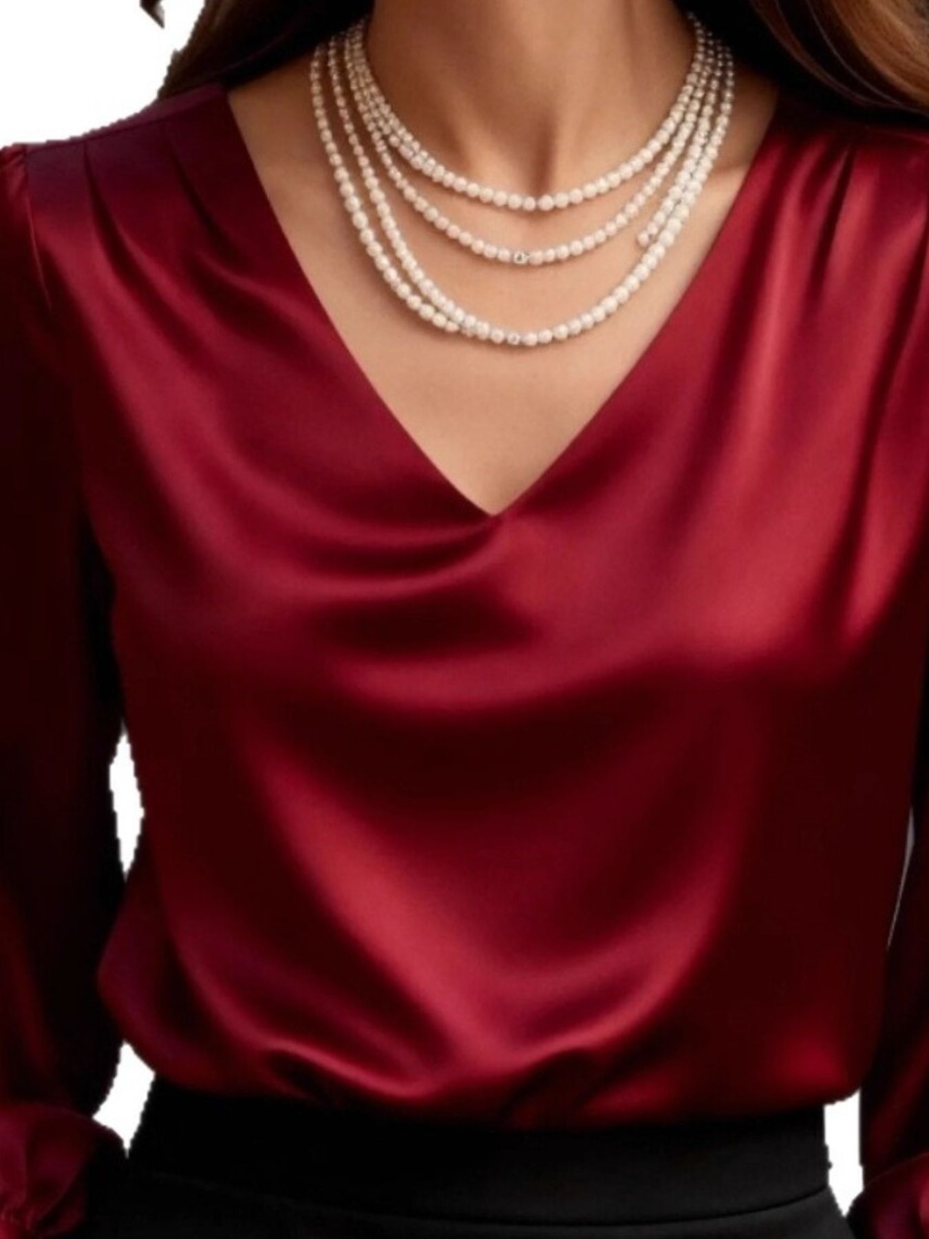 Red satin V-neck long sleeve blouse with draped neckline and pearl necklace