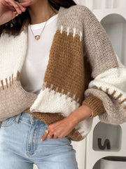 Brown and white striped open front cardigan with balloon sleeves.
