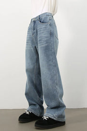 Oversized fade wash denim jeans in medium blue, relaxed fit, casual style.