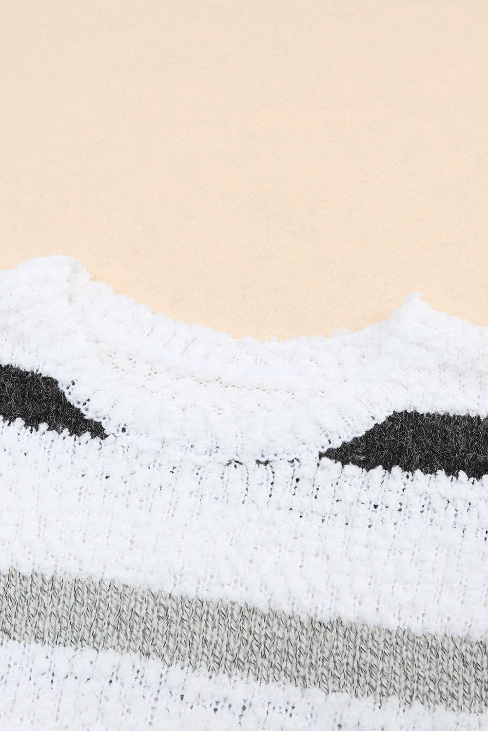 White acrylic sweater with textured stripes and a slouchy knit detail.